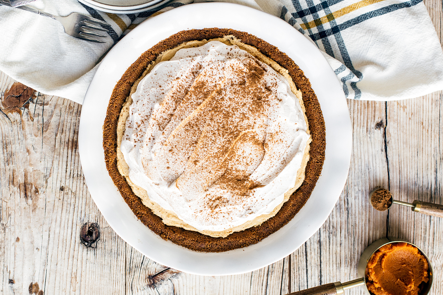 an unsliced No Bake Pumpkin Mousse Pie in its pie pan, ready to slice up and serve.
